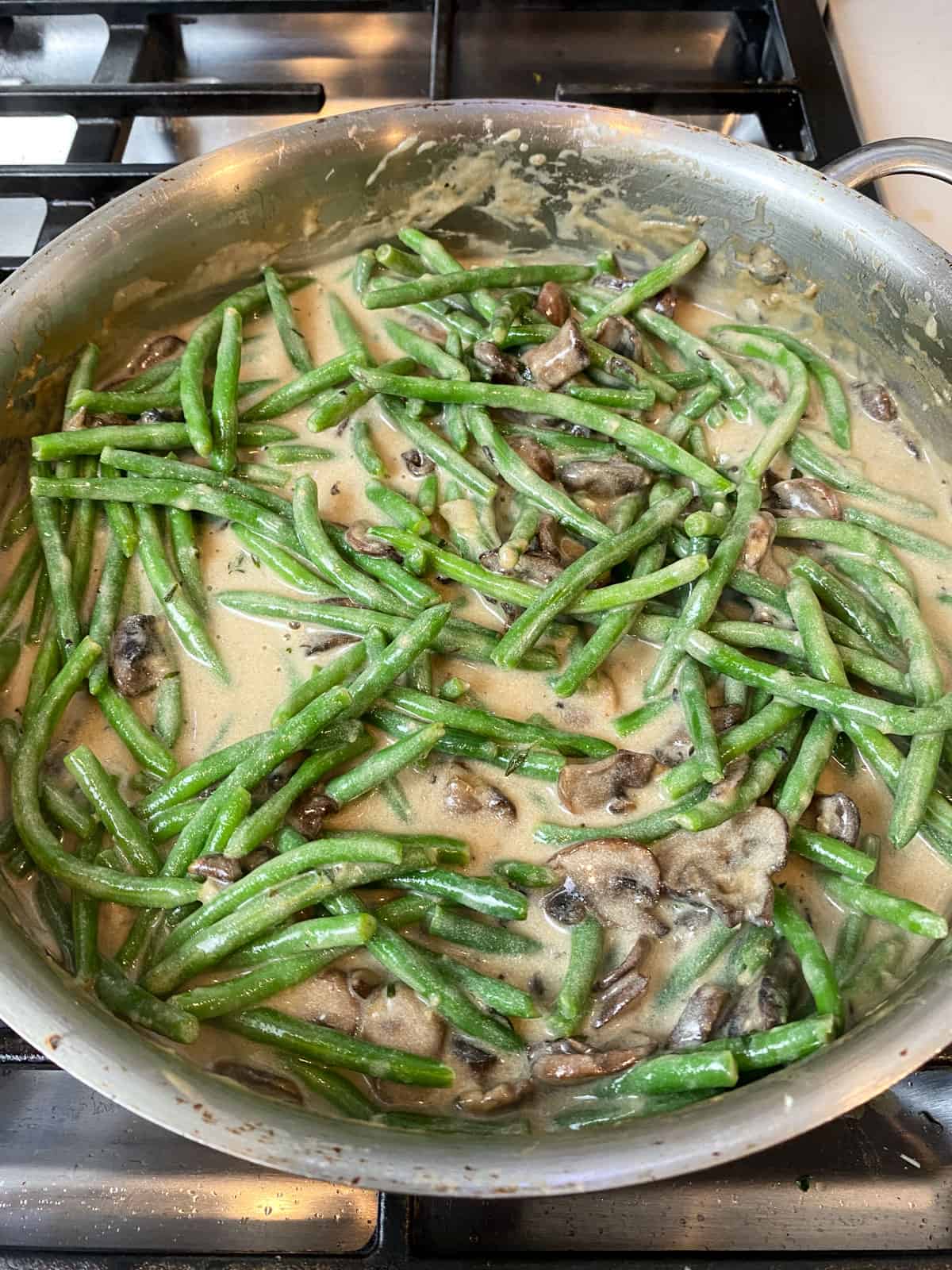 Add blanched green beans to the creamy mushroom mixture and toss to combine.