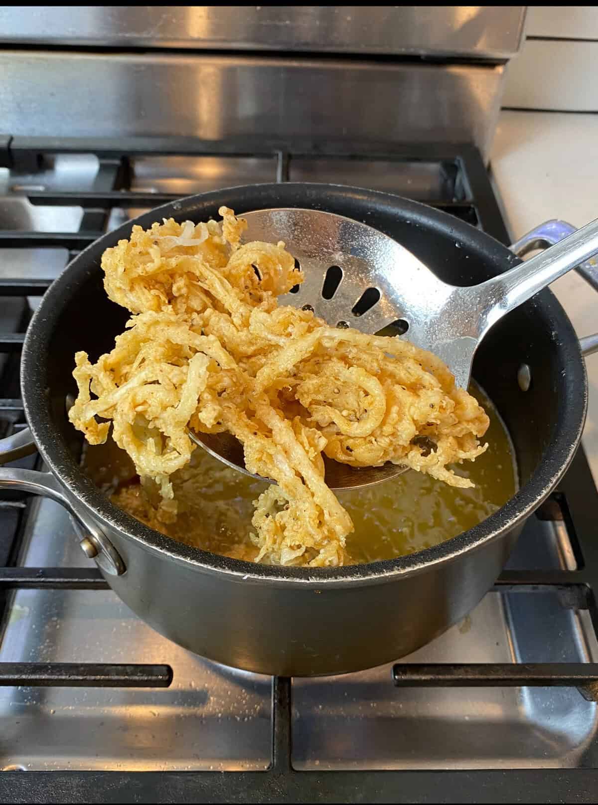 Fry the onions for a few minutes until golden brown and crispy.