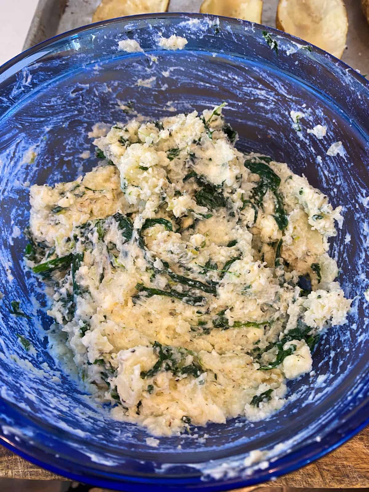 Mash the cooked potato with sauteed spinach, crumbled feta, sour cream and milk.