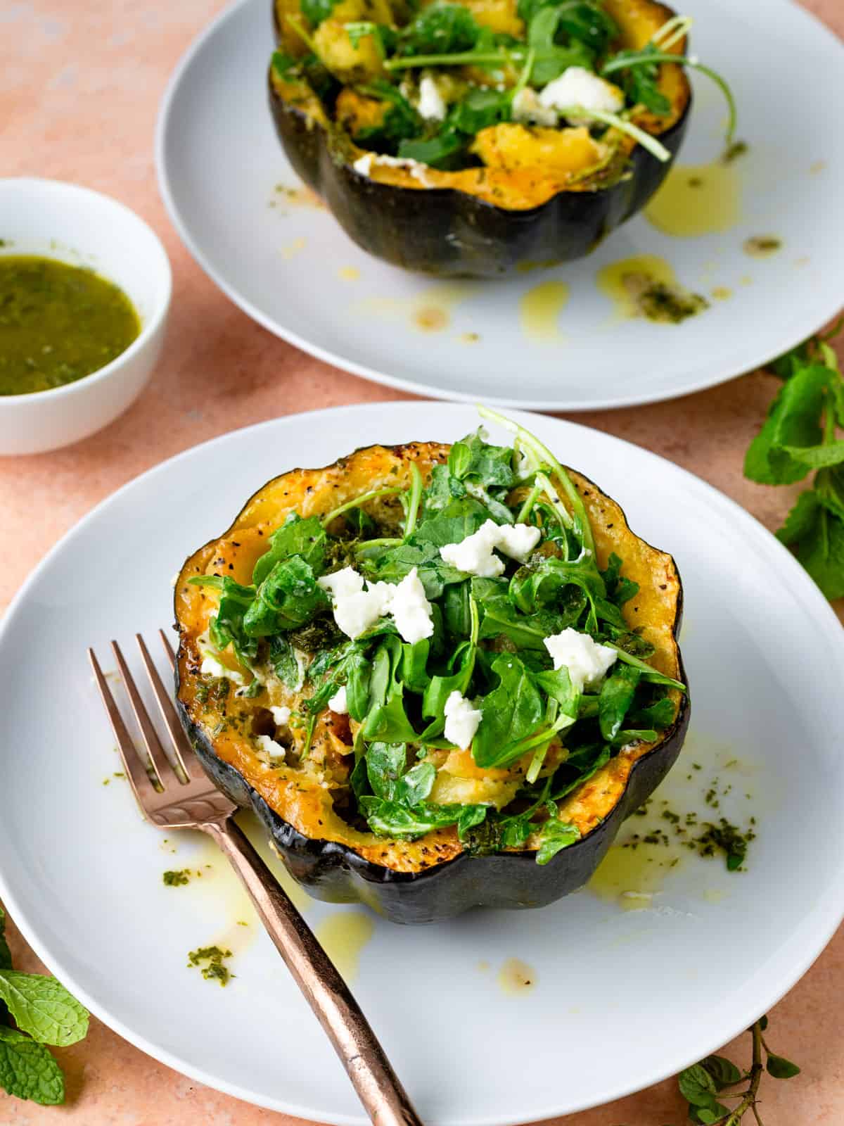 Roasted acorn squash halves with goat cheese, arugula and herb vinaigrette.