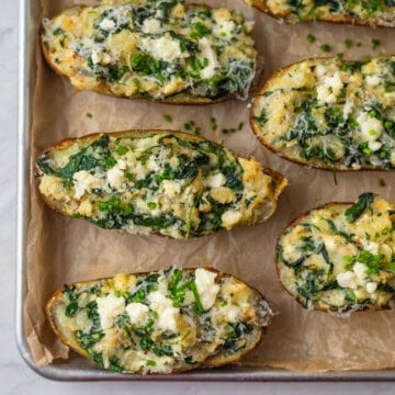 Spinach and feta baked potatoes with Parmesan cheese, green onions and Parmesan.