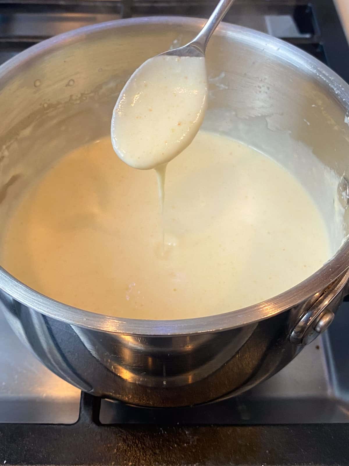 Stir the milk into the roux until the bechamel is thick enough to coat a spoon.