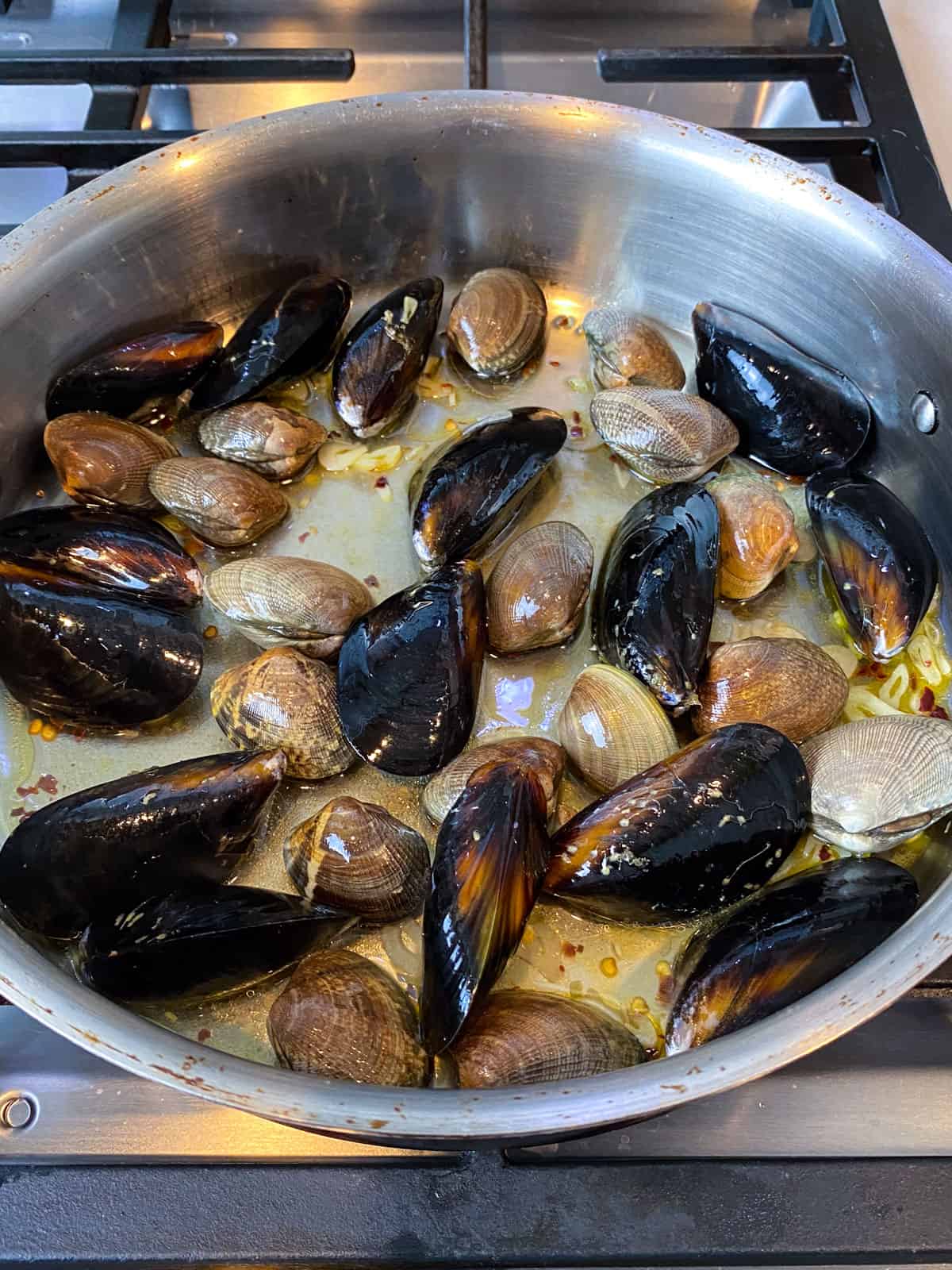 Add the mussels and clams to the sauteed garlic.