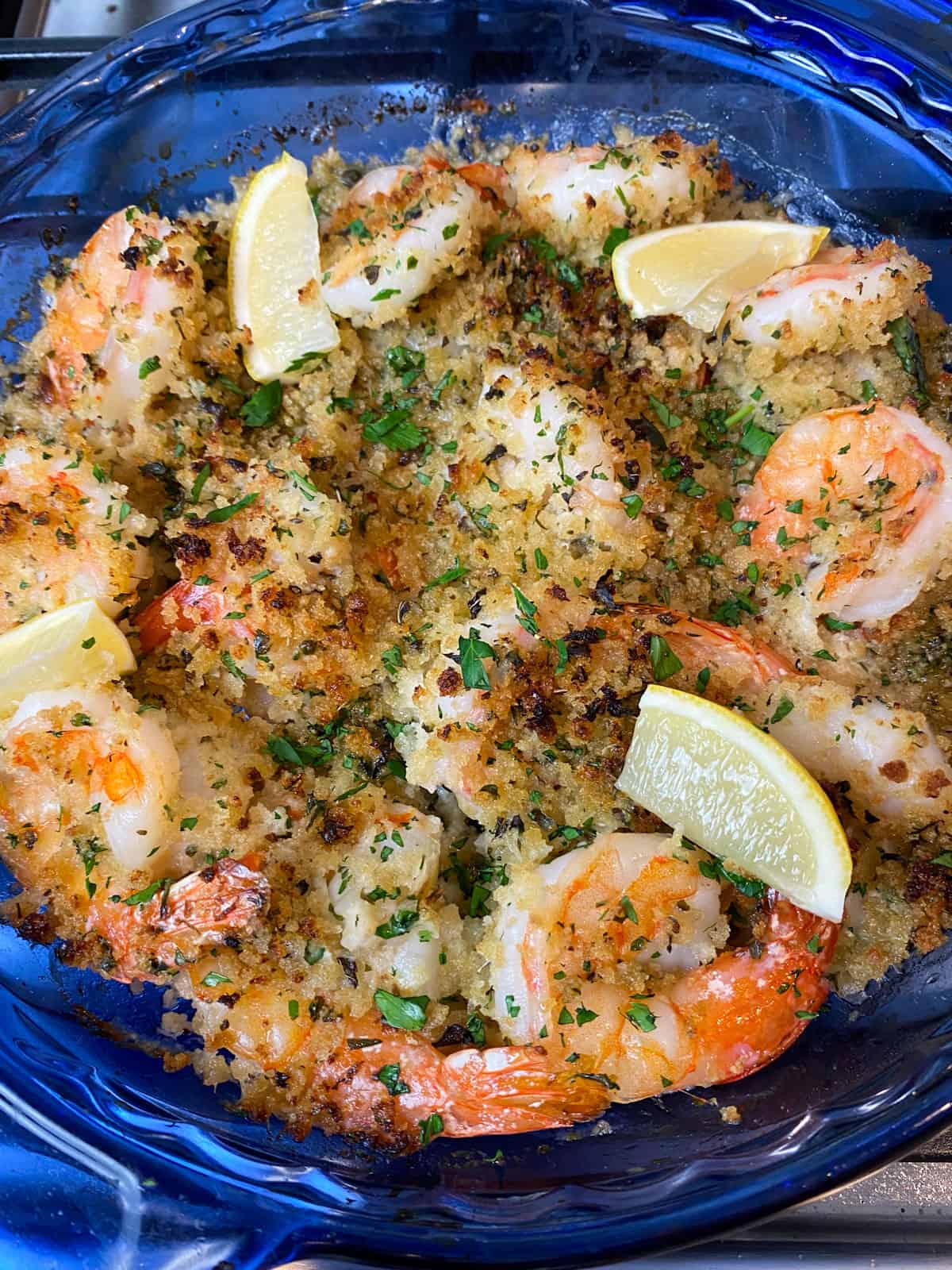 Bake the shrimp oreganata until the shrimp are just cooked through and breadcrumbs are crisp and golden.