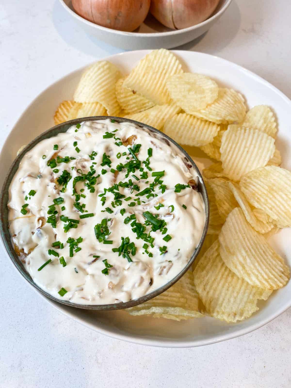 Garnish the onion dip with chopped fresh chives.