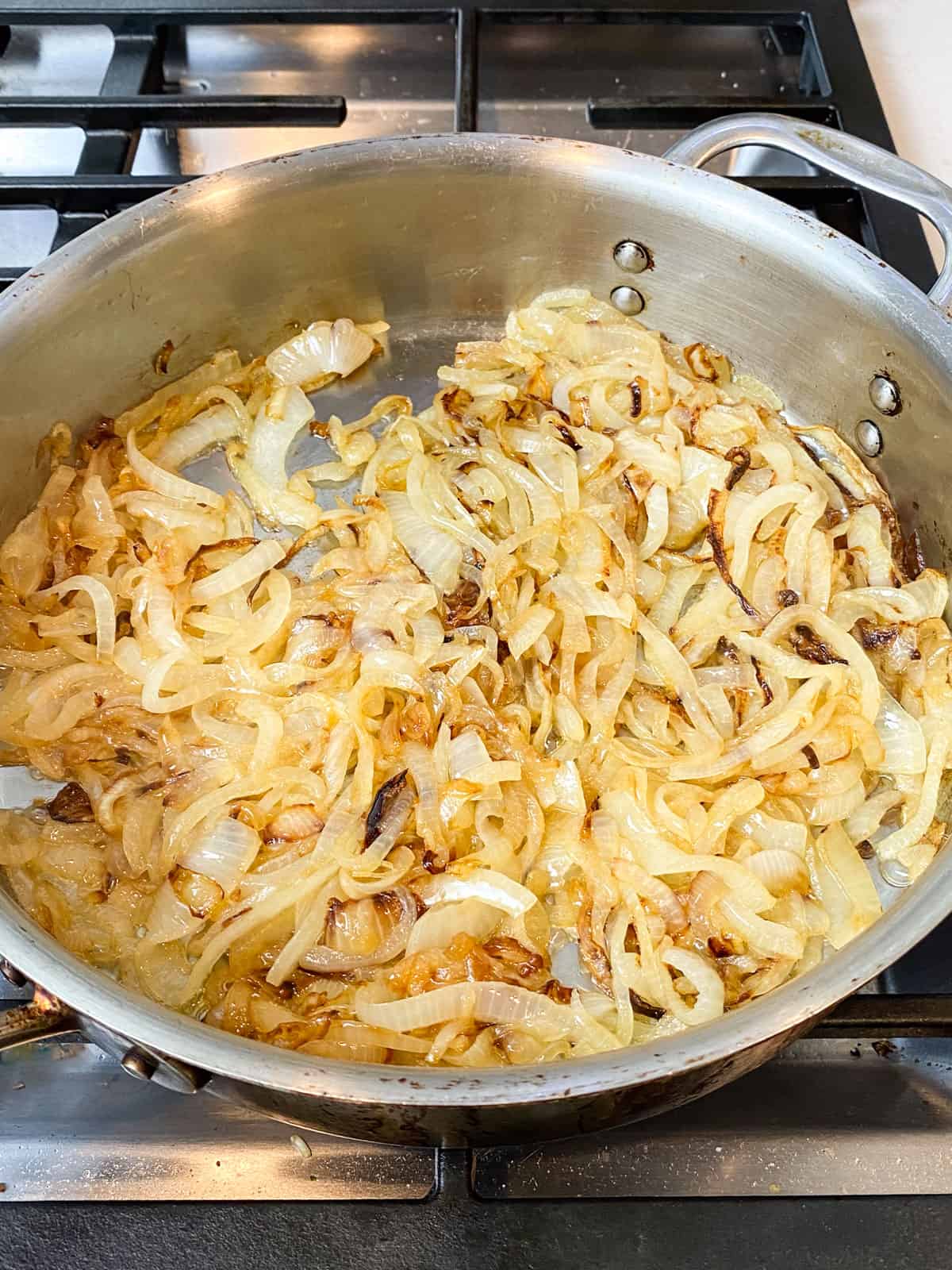 Halfway through cooking, the onions will begin to turn golden.