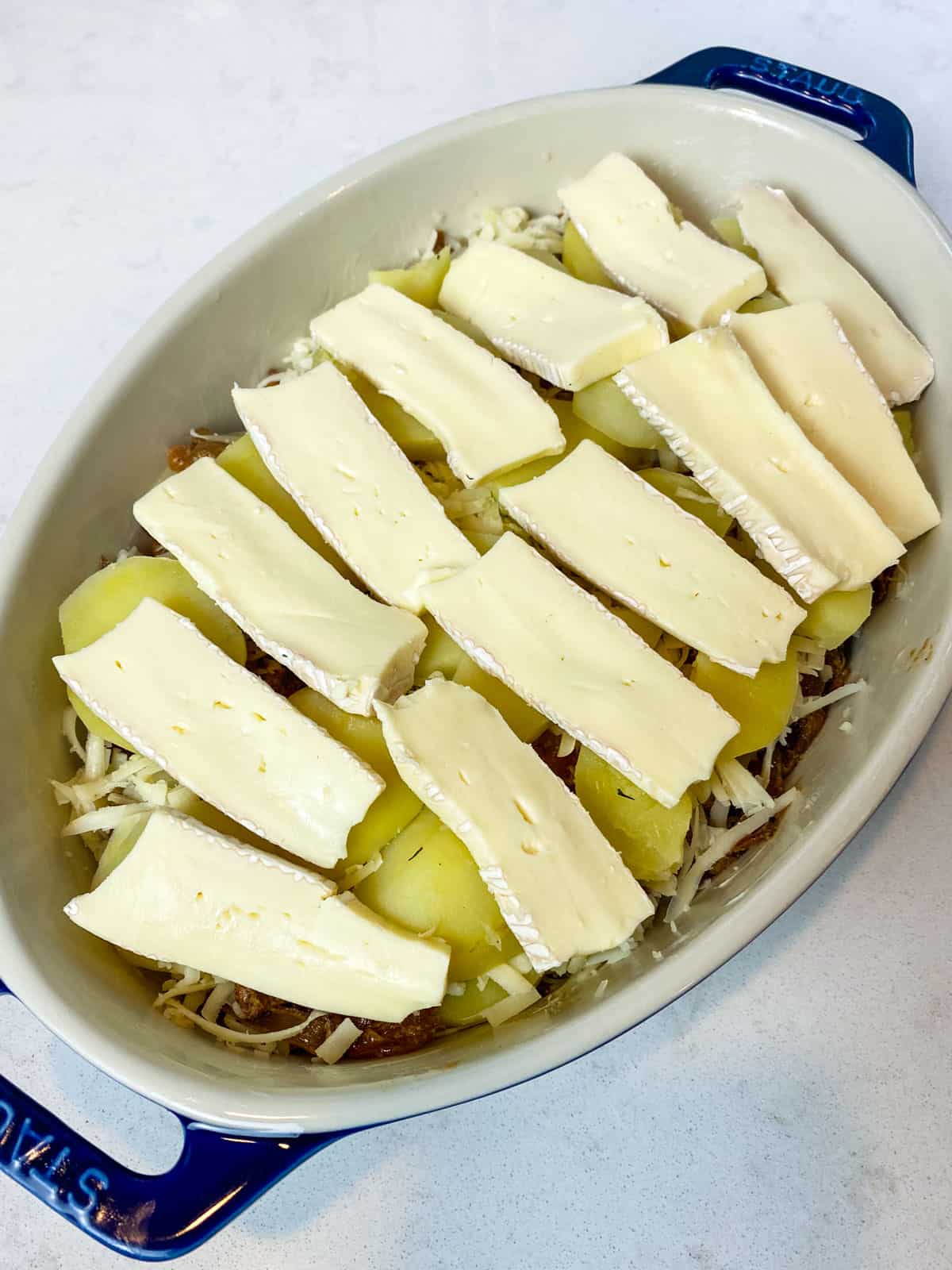 Layer sliced brie on top of the French potato casserole.