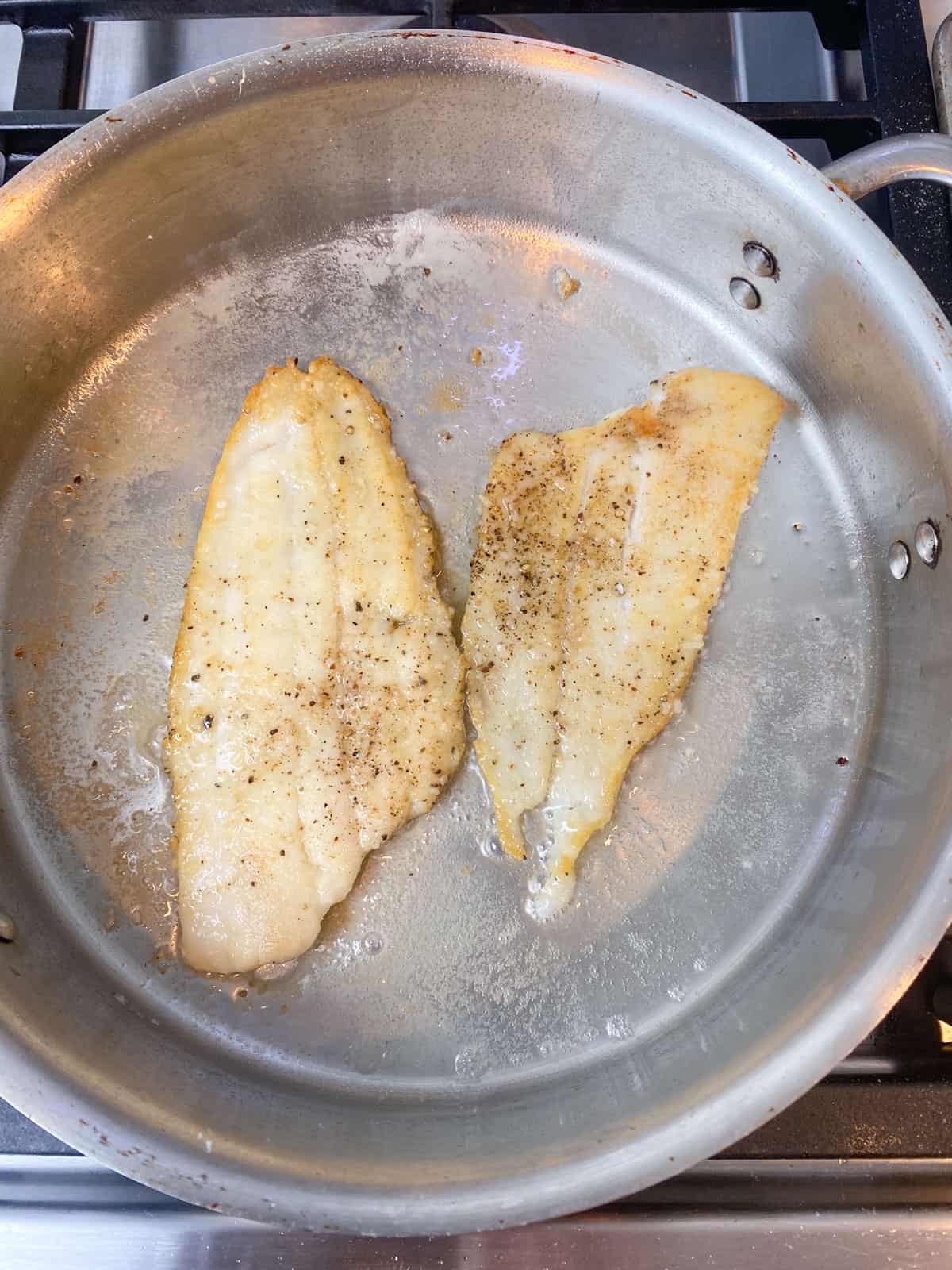 Sear the sole fillets in clarified butter until lightly golden.