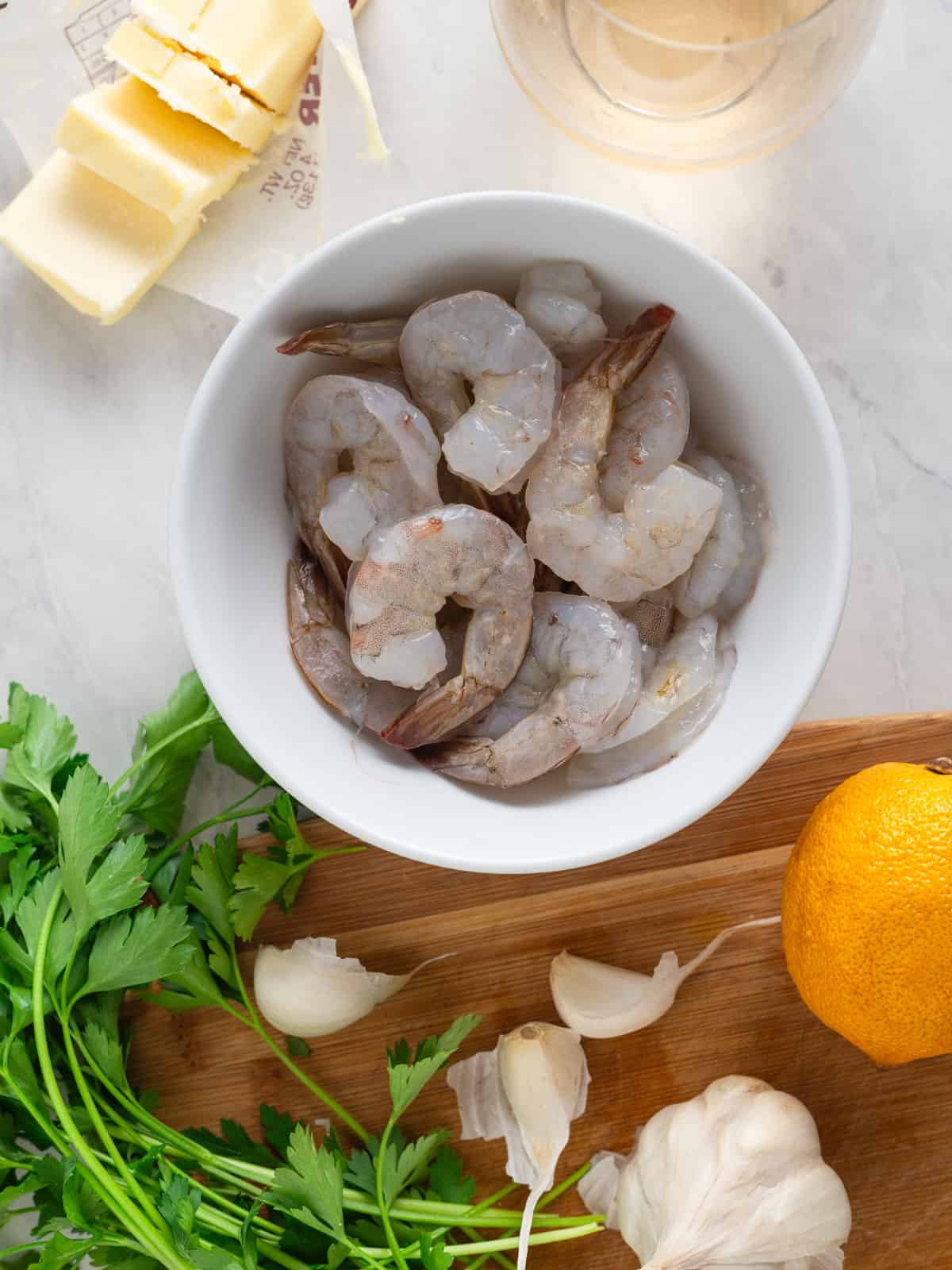 Ingredients for shrimp scampi, including lemon, white wine and butter.