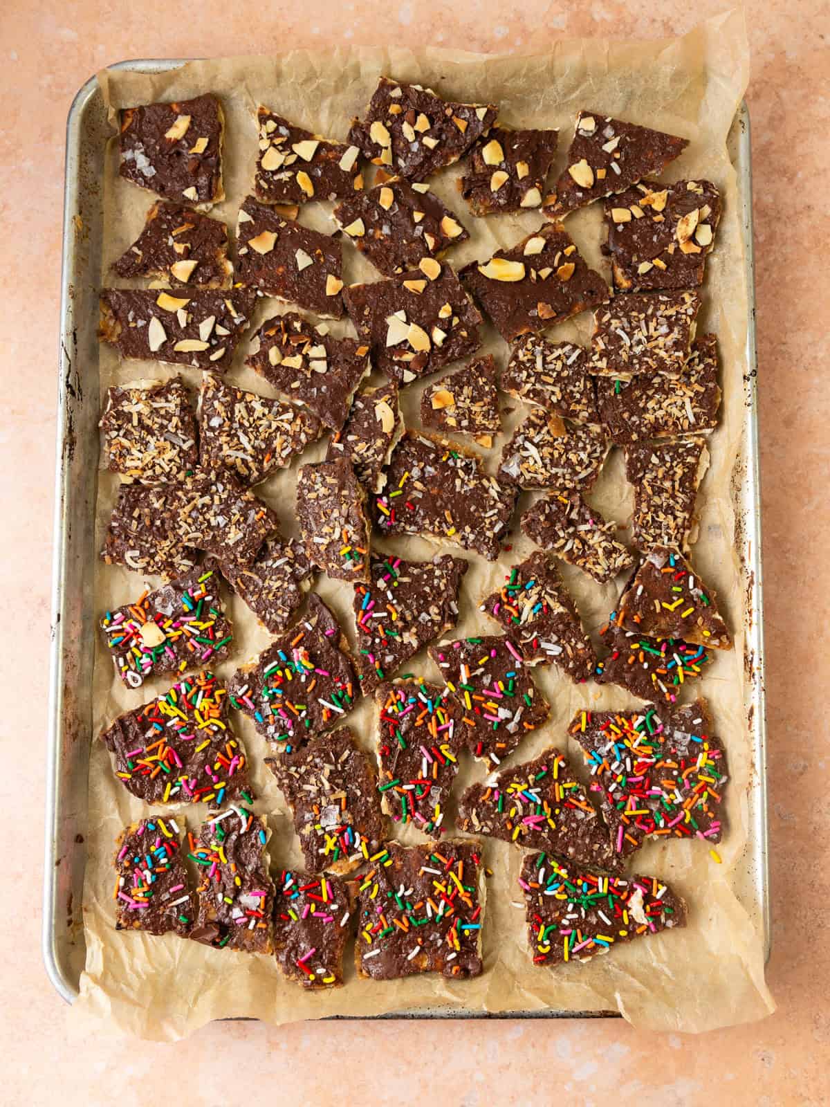 Chocolate matzo toffee topped with sea salt, toasted almonds, coconut and sprinkles.