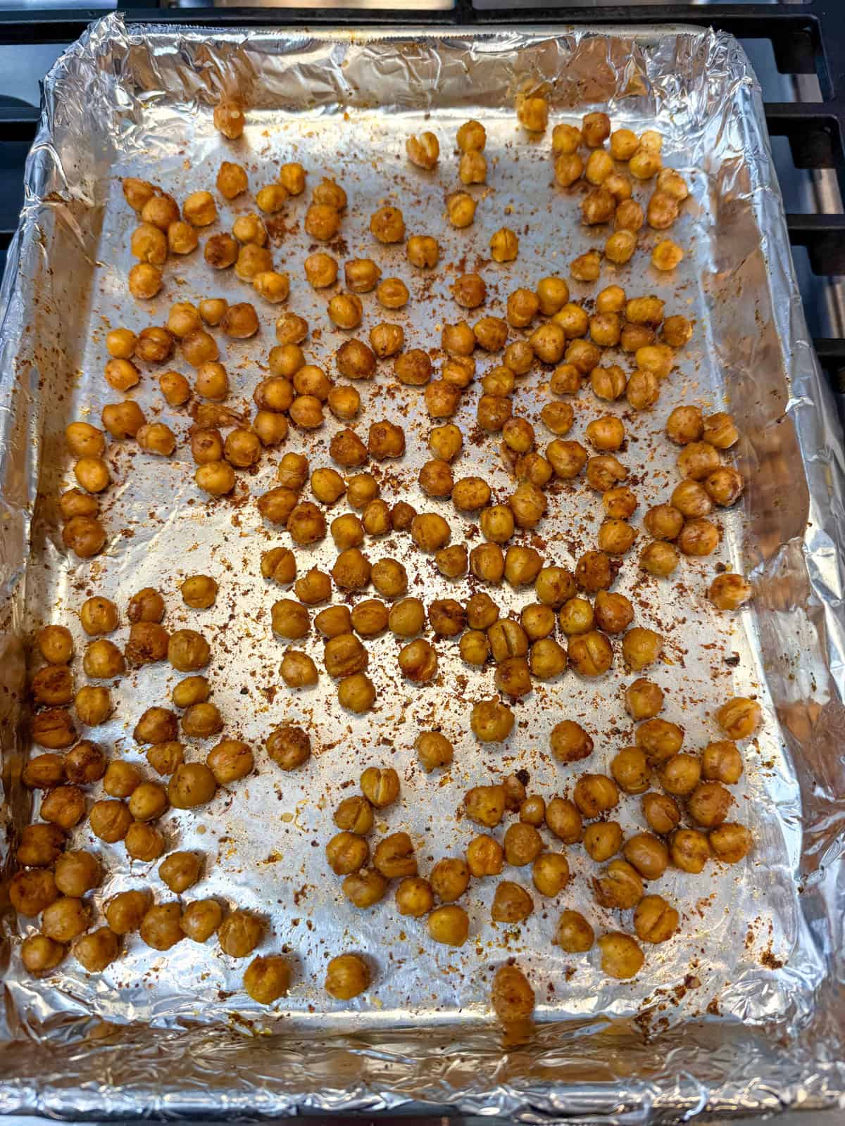 Season chickpeas with olive oil, paprika and cumin and roast at 425 degrees Fahrenheit for 20 minutes until crispy.