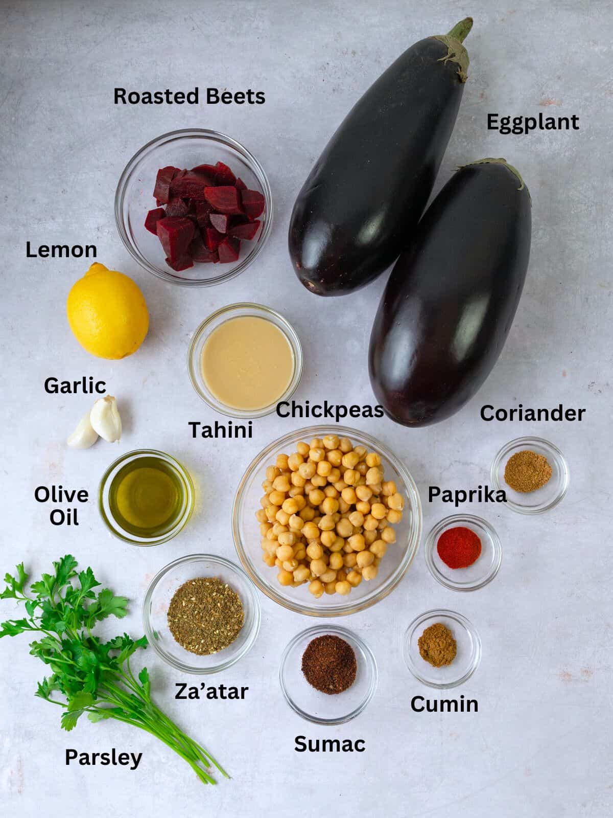 Ingredients for Mediterranean roasted eggplant with tahini, chickpeas and warm spices.