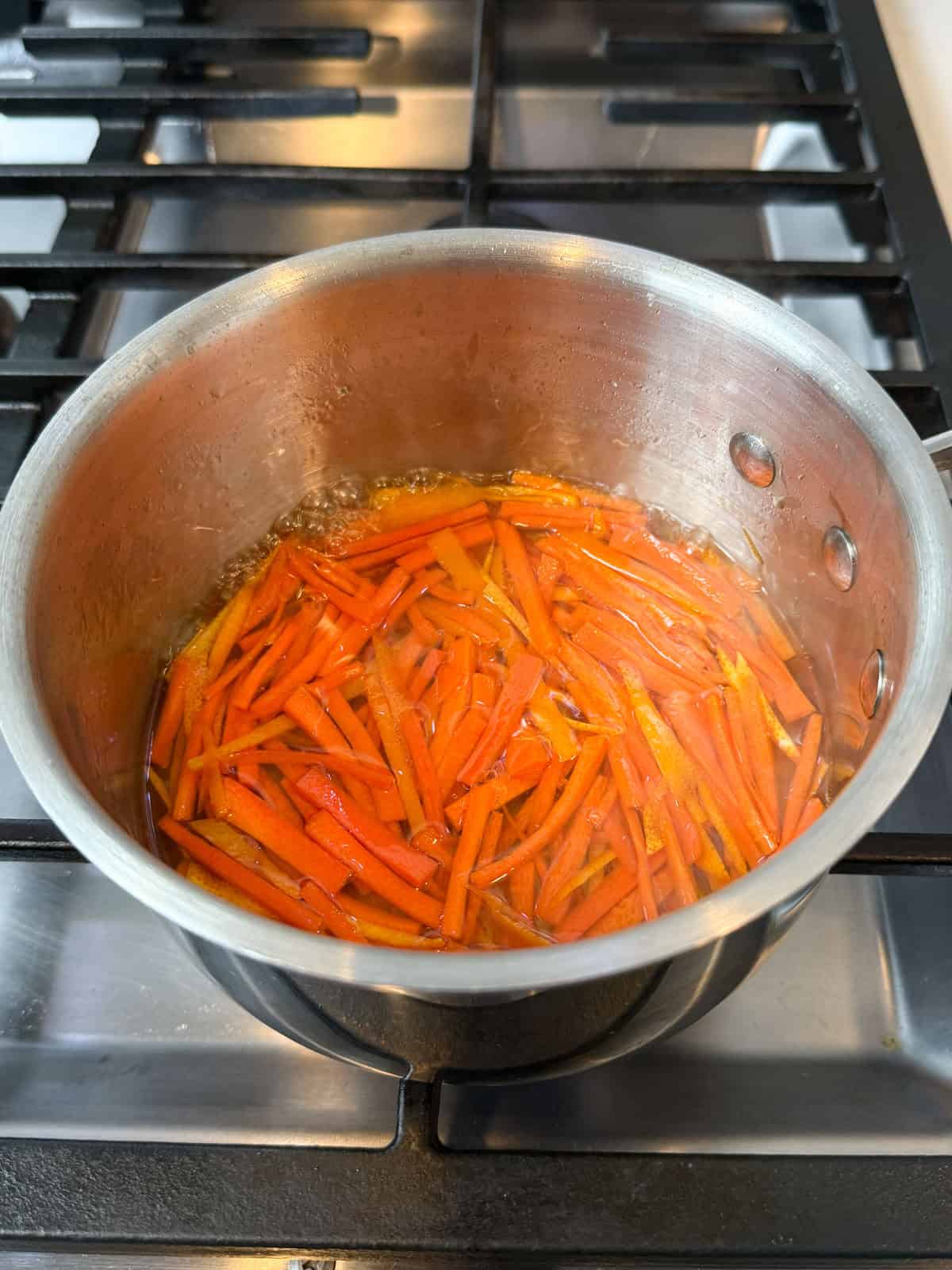 Make the candied orange peel and carrots with ½ cup of sugar and water.