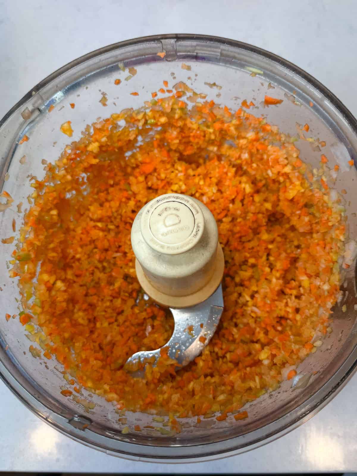 Finely chop the onions, carrots and celery in a food processor.