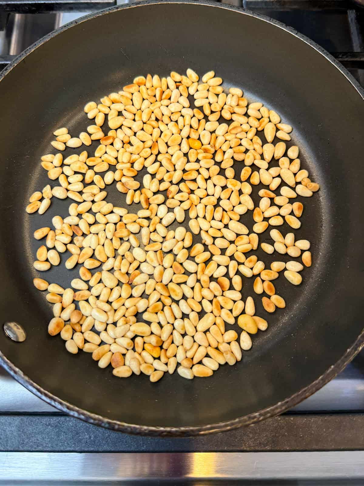 Toast the pine nuts in a dry pan for a few minutes until lightly golden.