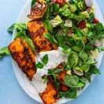 This salmon shawarma salad is full of bold flavors with a spiced salmon filet on top of bright greens.