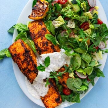 This salmon shawarma salad is full of bold flavors with a spiced salmon filet on top of bright greens.