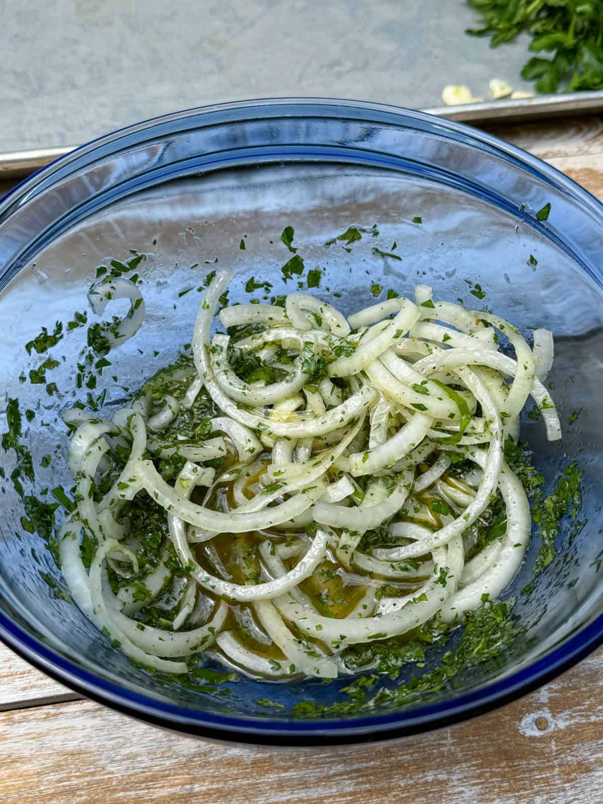 Toss the sliced onions with the herb sumac dressing.