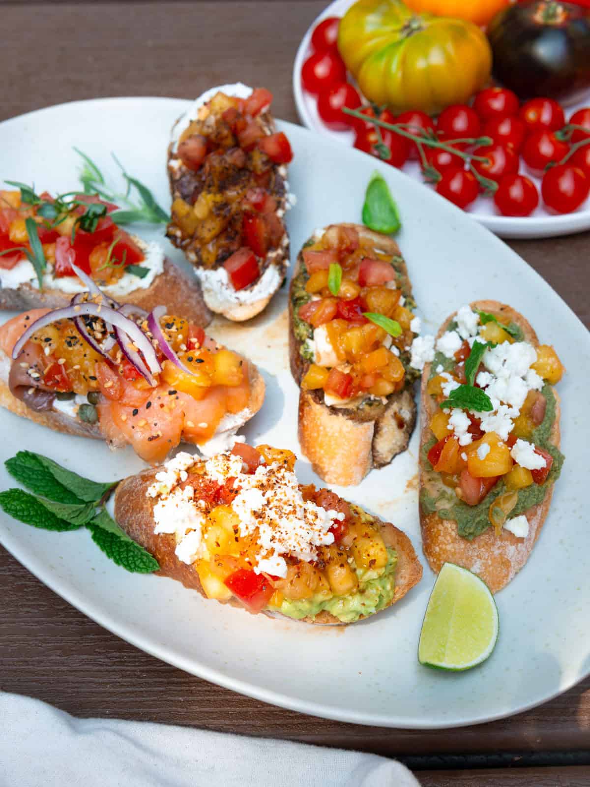 Tomato bruschetta with toppings inspired from flavors around the world.