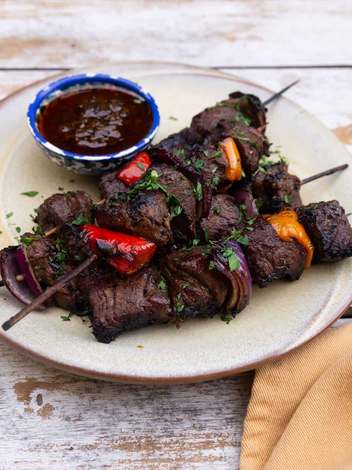 Grilled balsamic and herb steak skewers with peppers and onions.