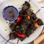 Grilled balsamic steak kabobs with vegetables and served with chimichurri.