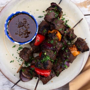 Grilled balsamic steak kabobs with vegetables and served with chimichurri.