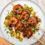 Grilled shrimp skewers with olives and preserved lemon.