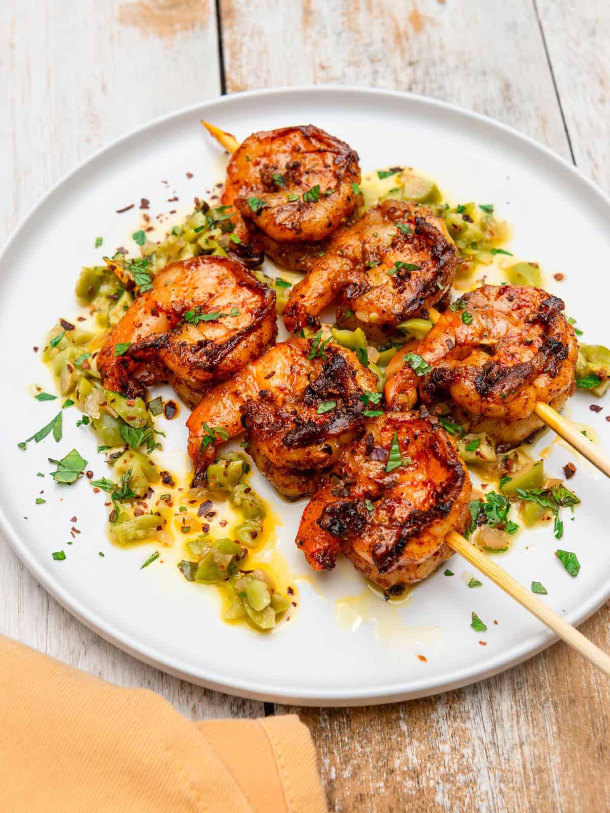 Smoky grilled shrimp skewers with preserved lemon and chopped olives.