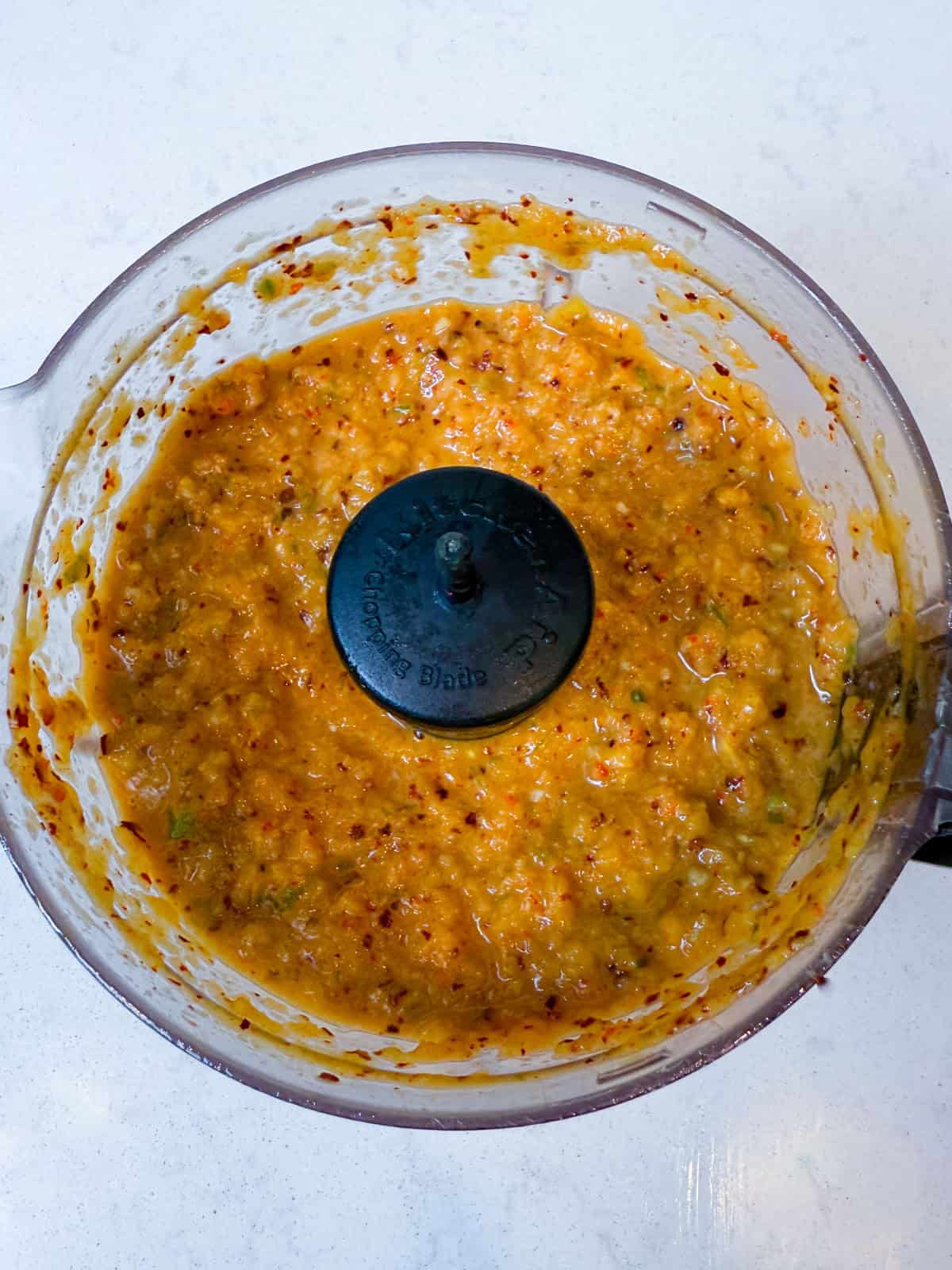 Add the pear, onion, green onion, garlic, ginger, soy sauce, Korean red pepper and sesame oil to a food processor and blend well.