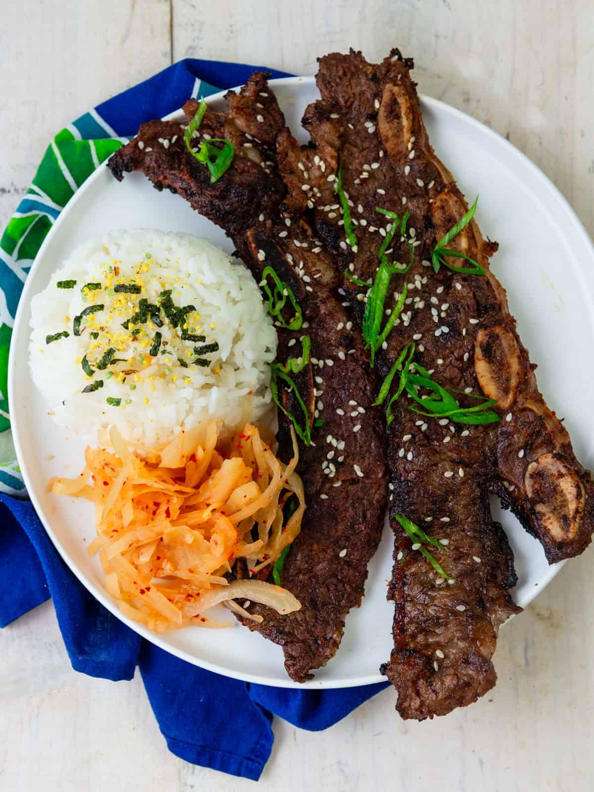 serve grilled galbi ribe with rice and kimchi.