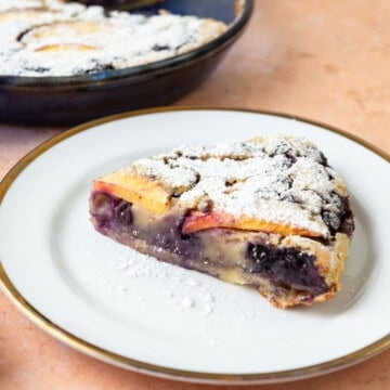 dust the blueberry peach clafoutis with powdered sugar and serve by the slice.