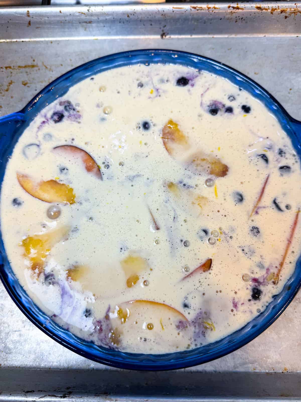 Pour the remaining clafoutis batter on top of the fruit layer bad bake until cooked through.