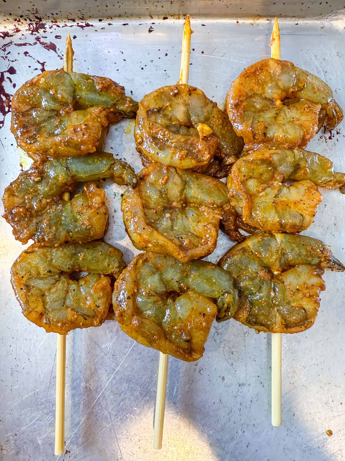 Season the raw shrimp and thread several onto a skewer.