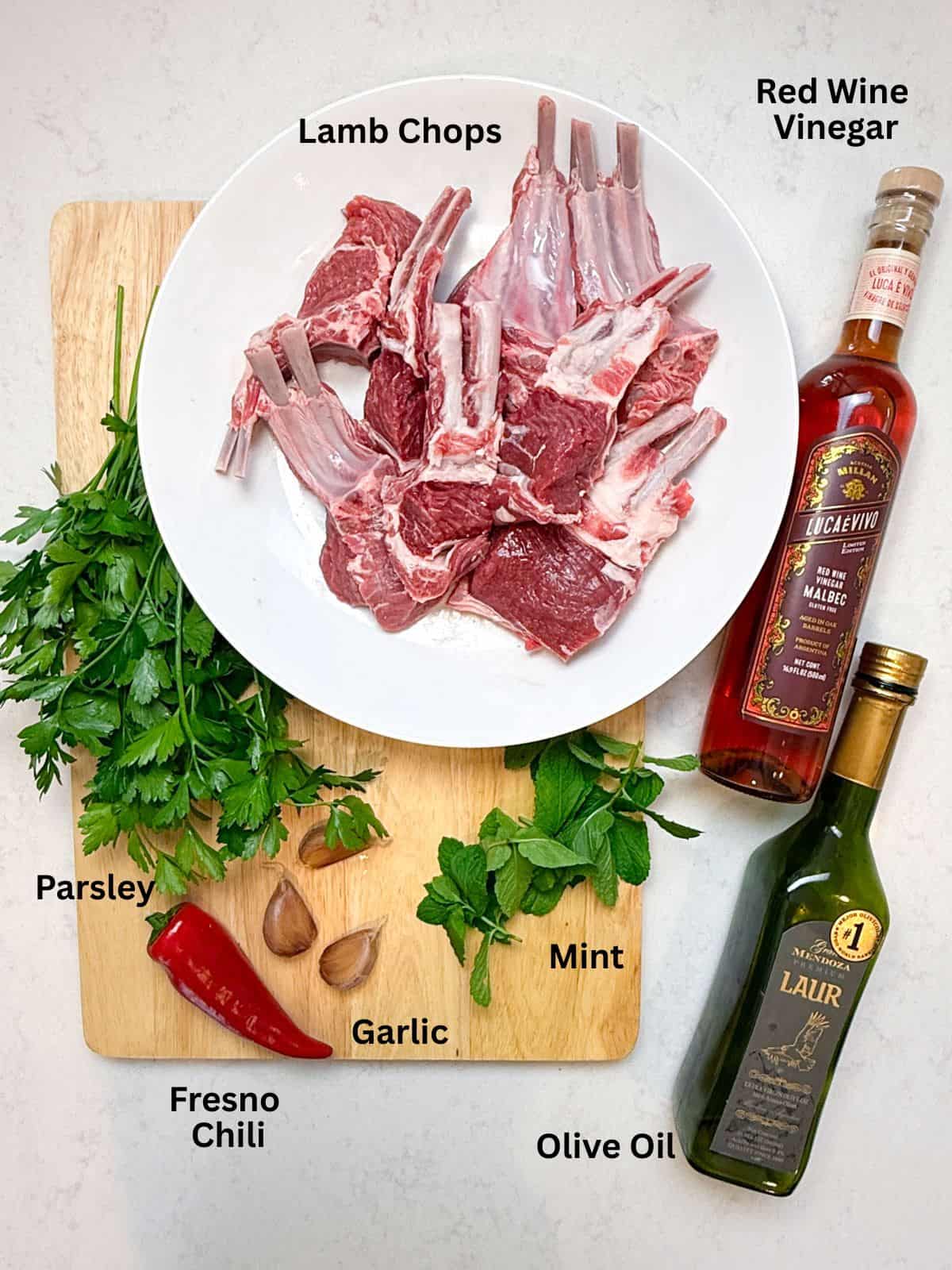 Ingredients for chimichurri marinated lamb chops, with olive oil, garlic, fresh herbs and red wine vinegar.
