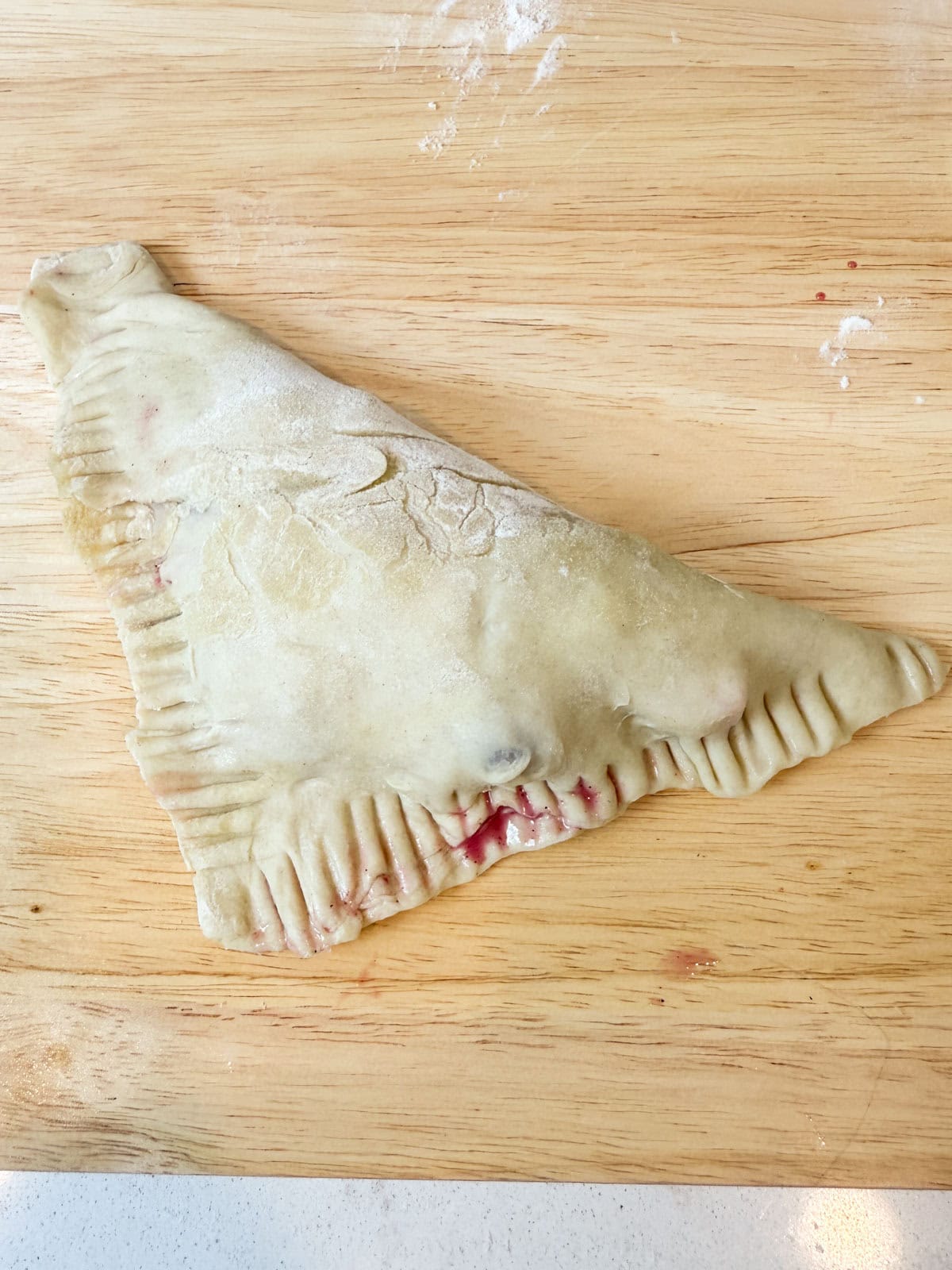 Fold the puff pastry over and crimp the edges to seal.