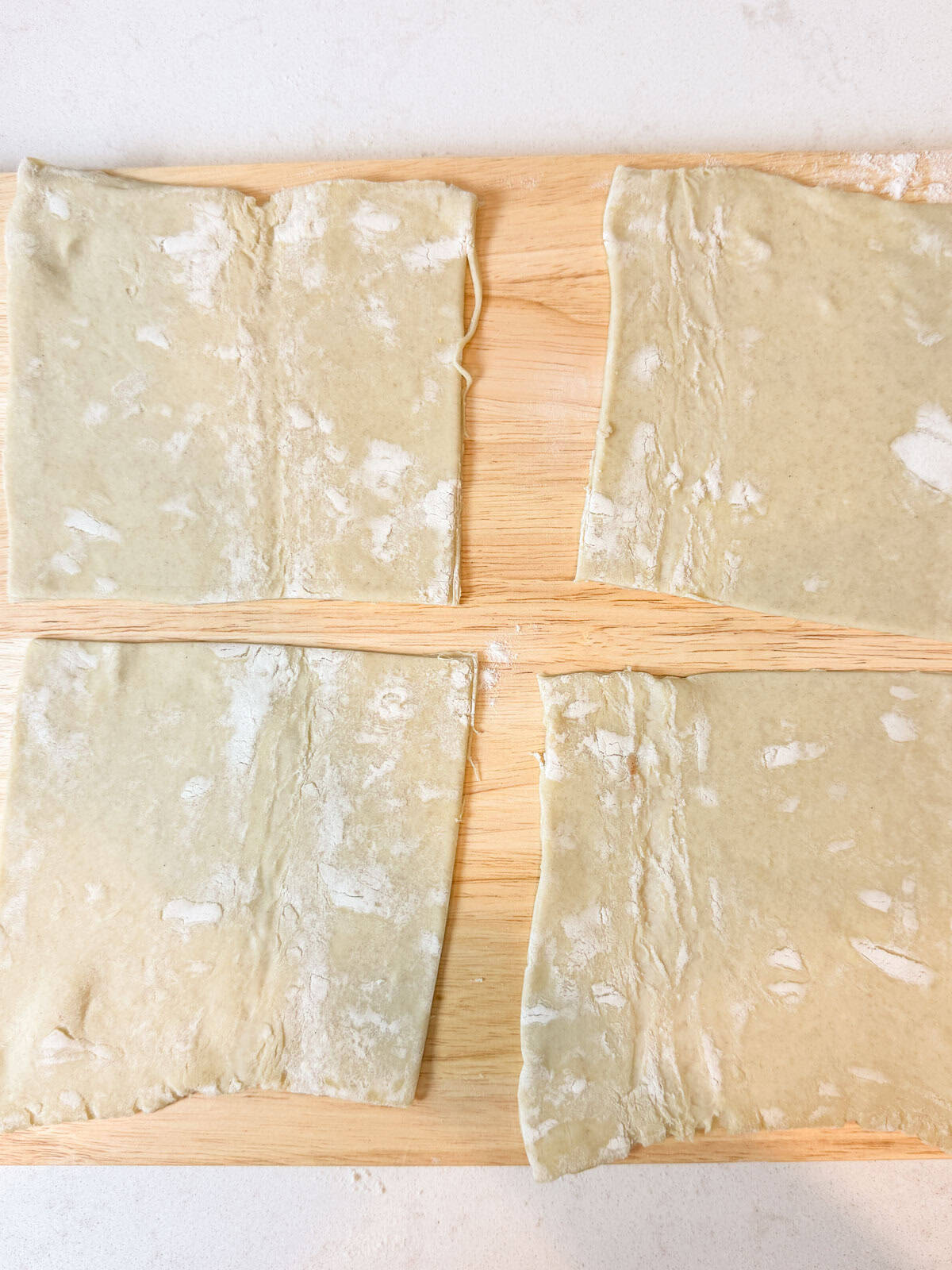 Cut the puff pastry into 4 squares.