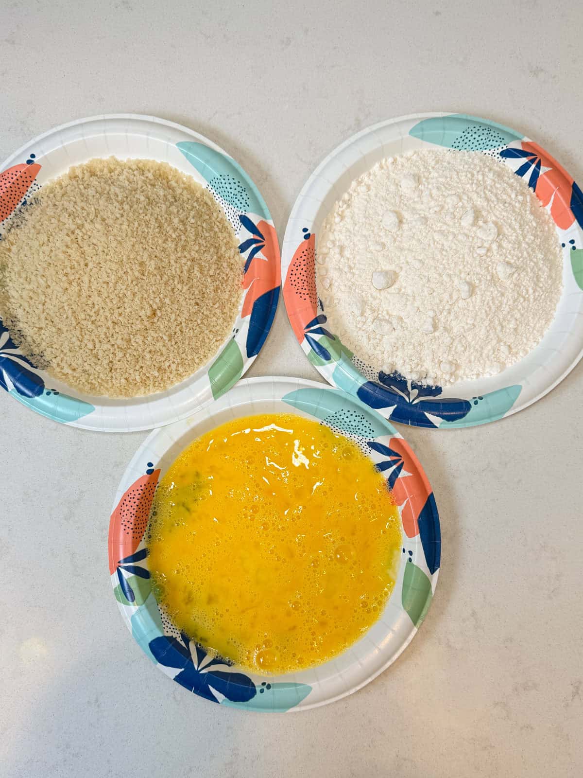 Set up a dredging station with flour, whisked eggs and breadcrumbs.