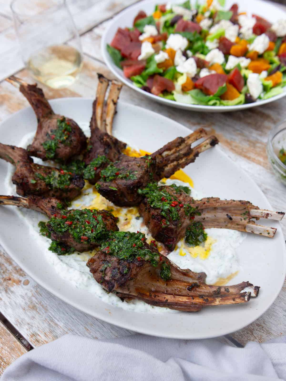 Grilled lamb chops with chimichurri and served over a creamy yogurt sauce.