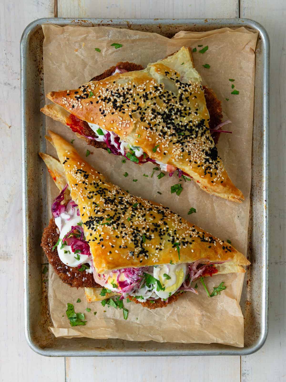 Sabich boreka with fried eggplant and layered with crunchy Mediterranean salads.