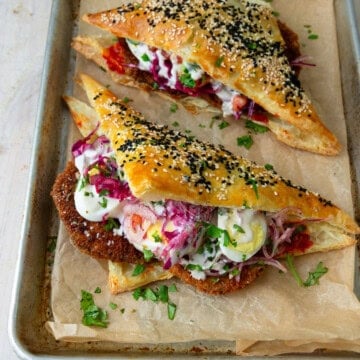 Fried eggplant and other sabich fillings are layered between buttery and flaky puff pastry.