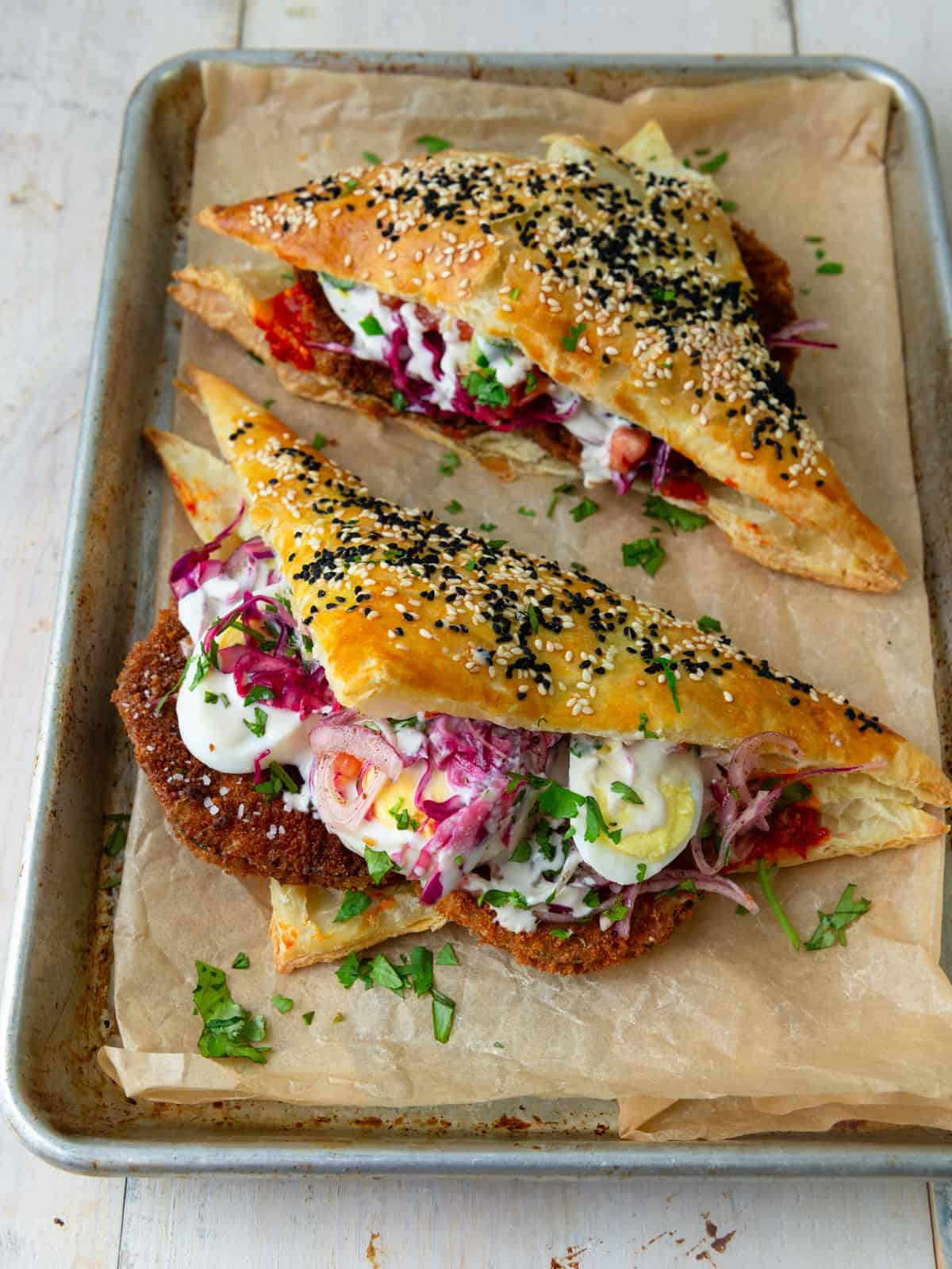 These sabich borekas are filled with fried eggplant, chopped salad, sumac onions and hard boiled egg.