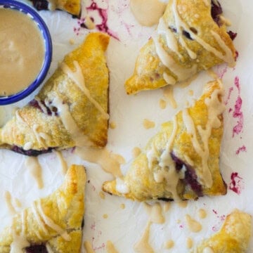 Sweet blueberry borekas with sweet honey tahini glaze.