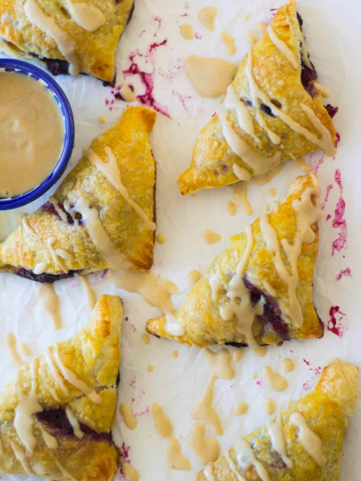 Apple and blueberry borekas drizzled with a sweet honey tahini glaze.
