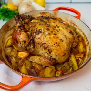 Recipe for Dutch oven roast chicken with lemon, herbs and vegetables.