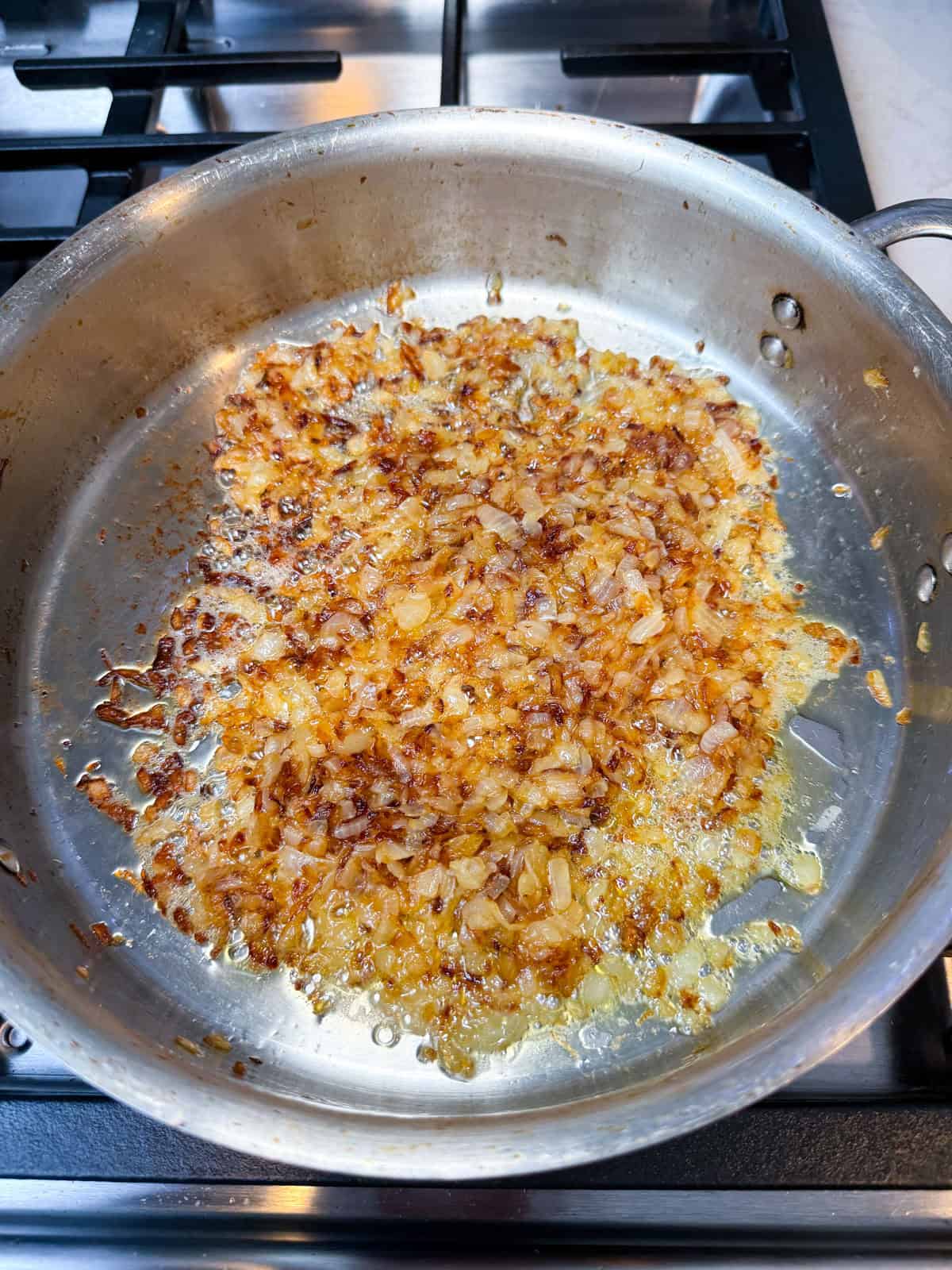 Continue caramelizing the onions past the golden state, so they deepen in color and reduce even more.