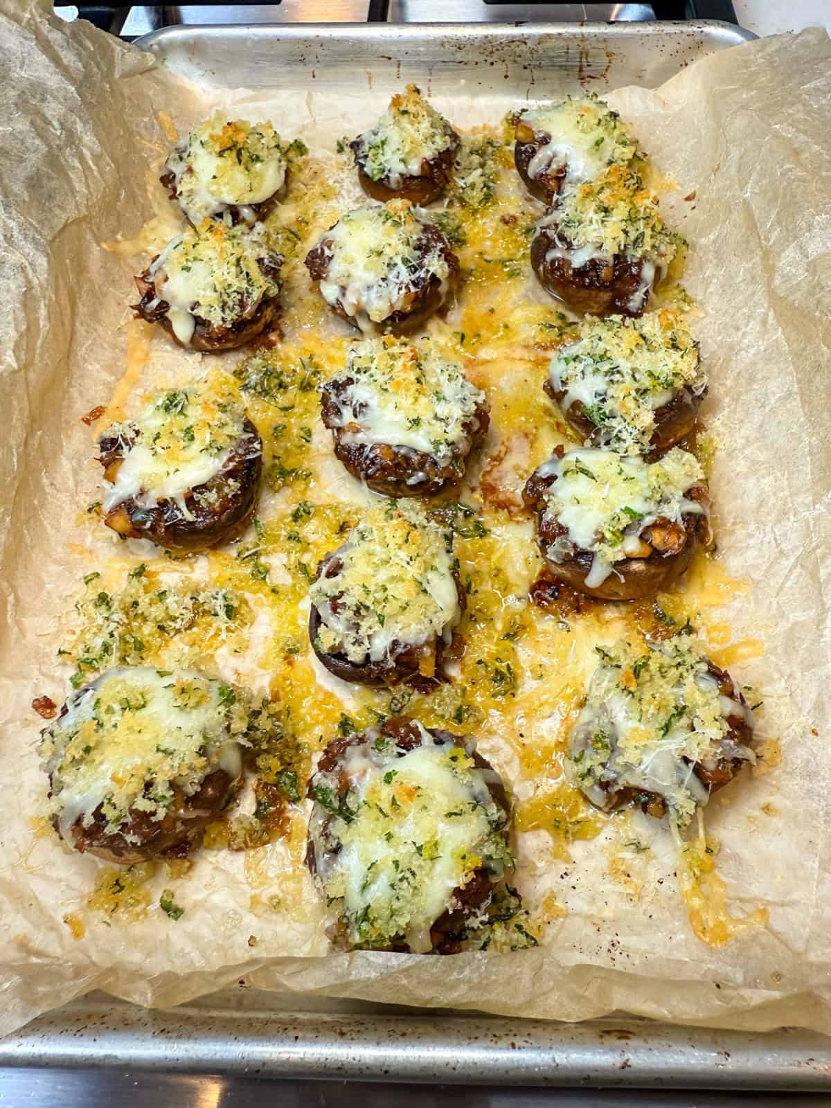 Bake the caramelized onion stuffed mushrooms until the cheese melts and the breadcrumb topping is golden and crisp.