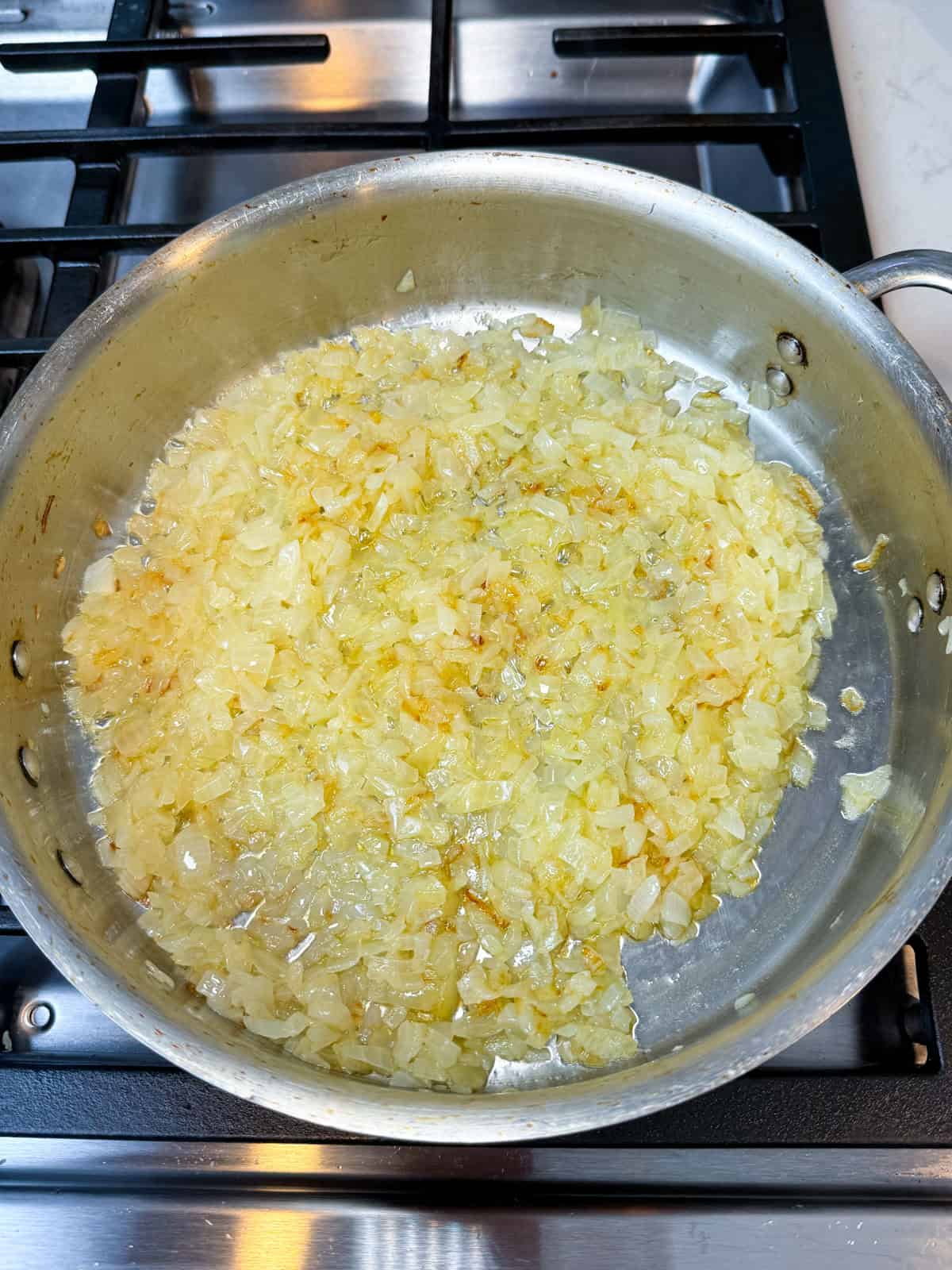 Start sautéing the chopped onions, giving them a mix every so often.