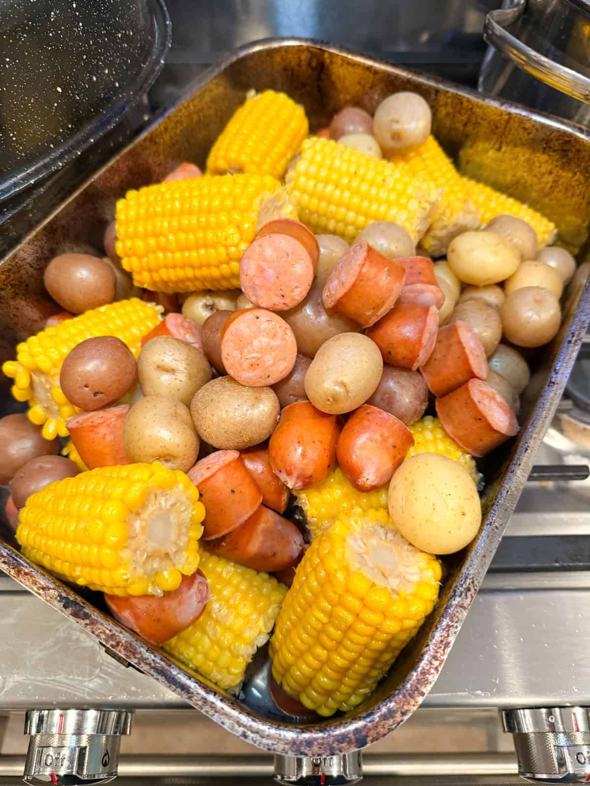 Remove the boiled potatoes and sausage before adding the lobsters.