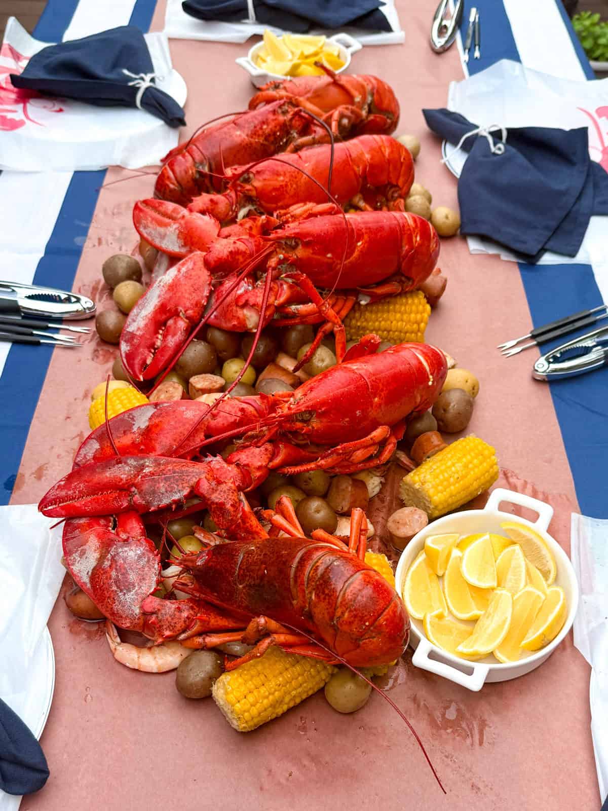 Lobster boil party with potatoes, corn and lemon.