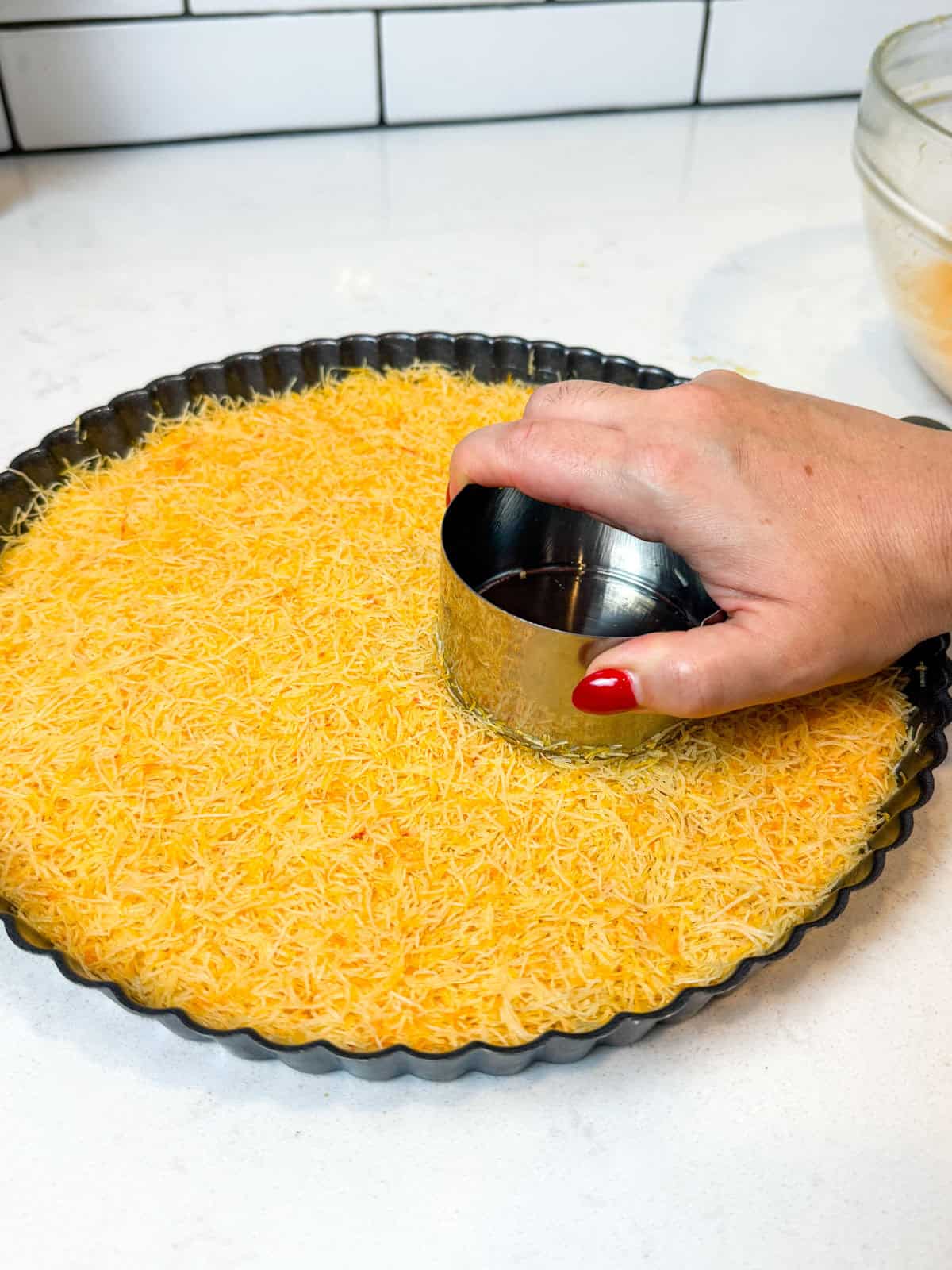 Press the bottom layer of the shredded phyllo into your dish.